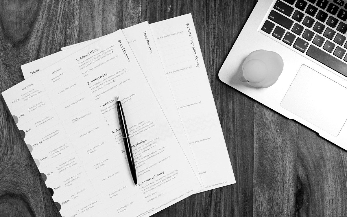 Website planning sheets laid out on a desk