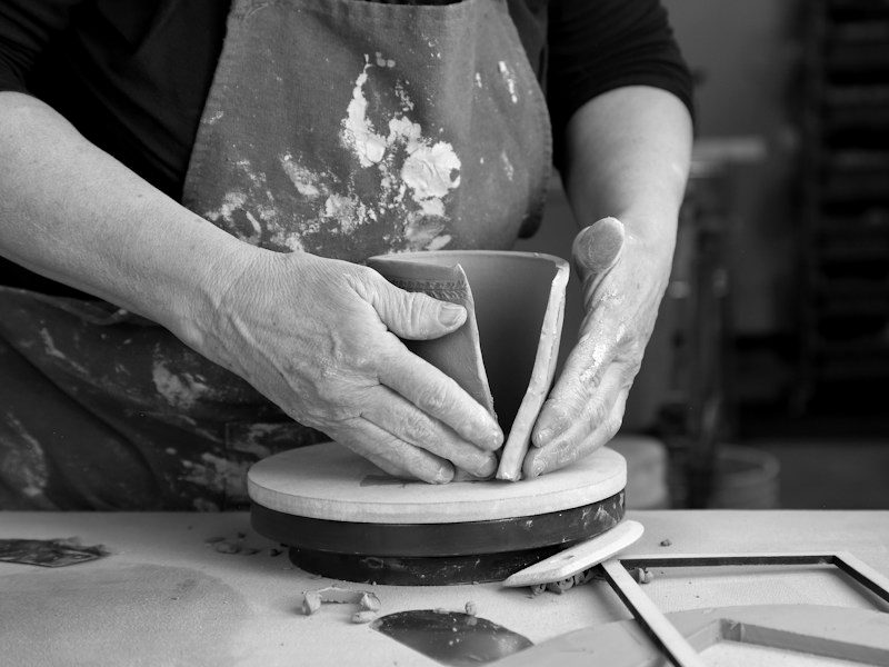 Potter shaping a piece by hand