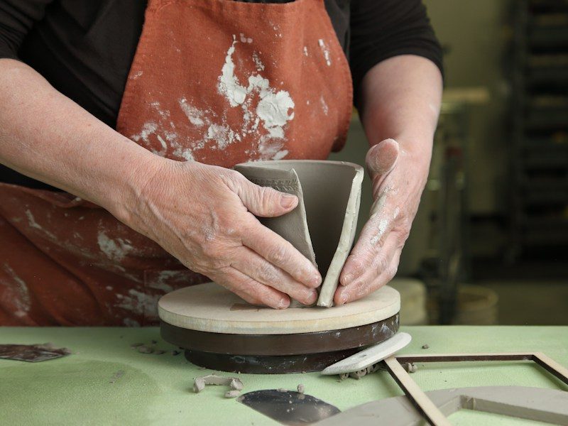 Potter shaping a piece by hand