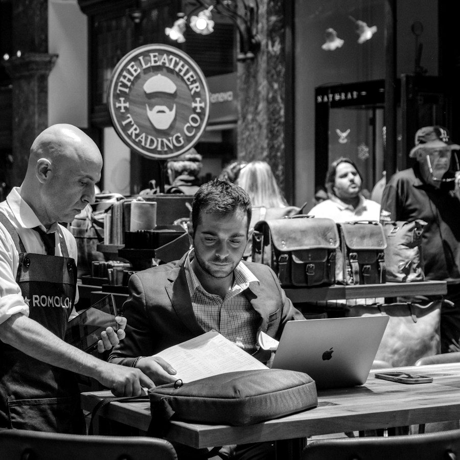 Shop owner following up on a customer file on a computer
